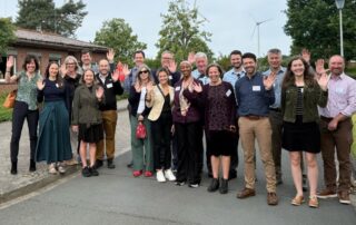 The 2026 Delegation at the Berlin Clean Energy Seminar waves and smiles at a site visit.